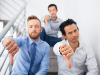 Group of multiethnic men showing thumb down